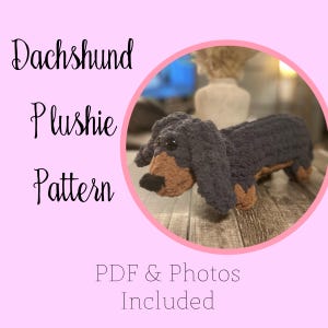 May include: A crocheted dachshund plushie in a pink circle, with a dark blue body, brown face and legs, and black nose. The text "Dachshund Plushie Pattern" is on the left, with "PDF & Photos Included" at the bottom.