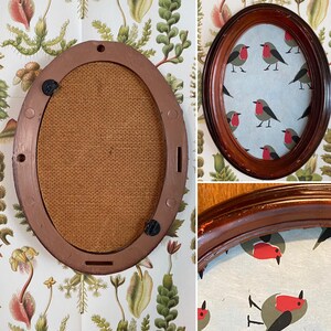 May include: A brown oval picture frame with a burlap backing. The frame is empty and ready for a picture. The frame is made of wood and has a simple design.