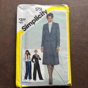 May include: Simplicity sewing pattern number 5751 for a skirt and jacket. The pattern is for size 12 miss. The pattern shows a woman wearing a striped skirt and jacket, and two other women wearing pants and jackets. The pattern is yellow with black text. The price is $3.50 U.S. and £1.65 U.K.