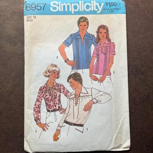 May include: Vintage Simplicity sewing pattern 6957, size 12 Miss. The pattern features illustrations of shirts with various designs, including a blue shirt with vertical stripes, a pink shirt, and a white shirt with a lace-up front.
