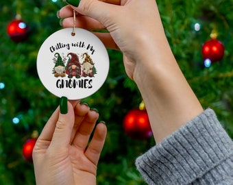 May include: White ceramic Christmas bauble featuring a red and green gnome design. The bauble reads "Chilling with my Gnomies".