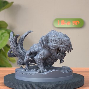 May include: A gray, detailed, 3D printed miniature of a monstrous creature with multiple eyes and a gaping maw. The creature has a long, segmented tail and stands on a round base.