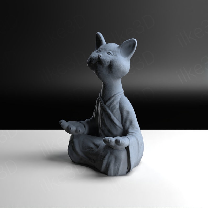 Op de afbeelding: Een grijs keramiek beeldje van een kat die in meditatieve houding zit met zijn ogen dicht. De kat draagt een gewaad en heeft een serene uitdrukking op zijn gezicht.