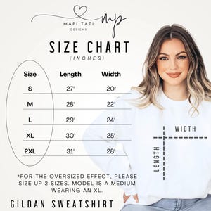 May include: Size chart for a Gildan sweatshirt in inches. The chart shows the length and width of the sweatshirt in sizes S, M, L, XL, and 2XL. The chart also includes a note that for an oversized effect, the customer should size up two sizes. The model is wearing a medium size and is wearing an XL size sweatshirt.