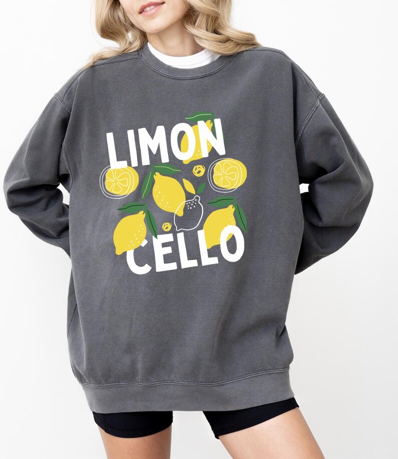 May include: A dark gray sweatshirt with a white graphic print of lemons and the text "LIMON CELLO".