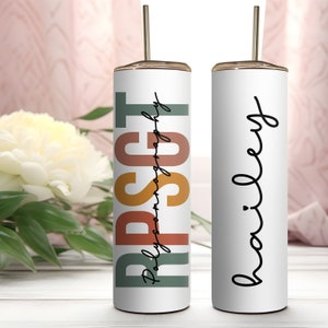 May include: Two stainless steel tumblers with lids and straws. One tumbler has the text "RPSCT" in colorful vertical letters with the text "Polyamorygraphy" underneath. The other tumbler has the text "bailey" in cursive.