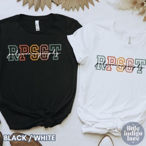 May include: Two t-shirts, one black and one white, with the text "RPSGT Polygraphy" in colorful block letters. The text is in a retro style with a handwritten script underneath.