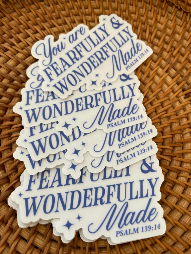 May include: A stack of white stickers with blue text that reads "You are fearfully and wonderfully made" and "Psalm 139:14".
