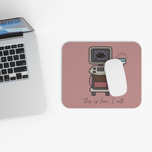 May include: Pink mouse pad with a cartoon illustration of an ultrasound machine and the text "This is how I roll".