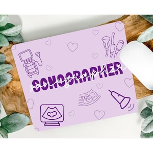 May include: Purple and white mouse pad with the word "SONOGRAPHER" in purple script. The mouse pad features various ultrasound-related icons, including a heart, a baby, and an ultrasound machine.