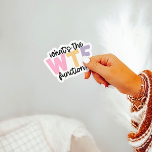 May include: A white sticker with the text "what's the WTF function!" in black. The letters in "WTF" are in pink, yellow, and purple.