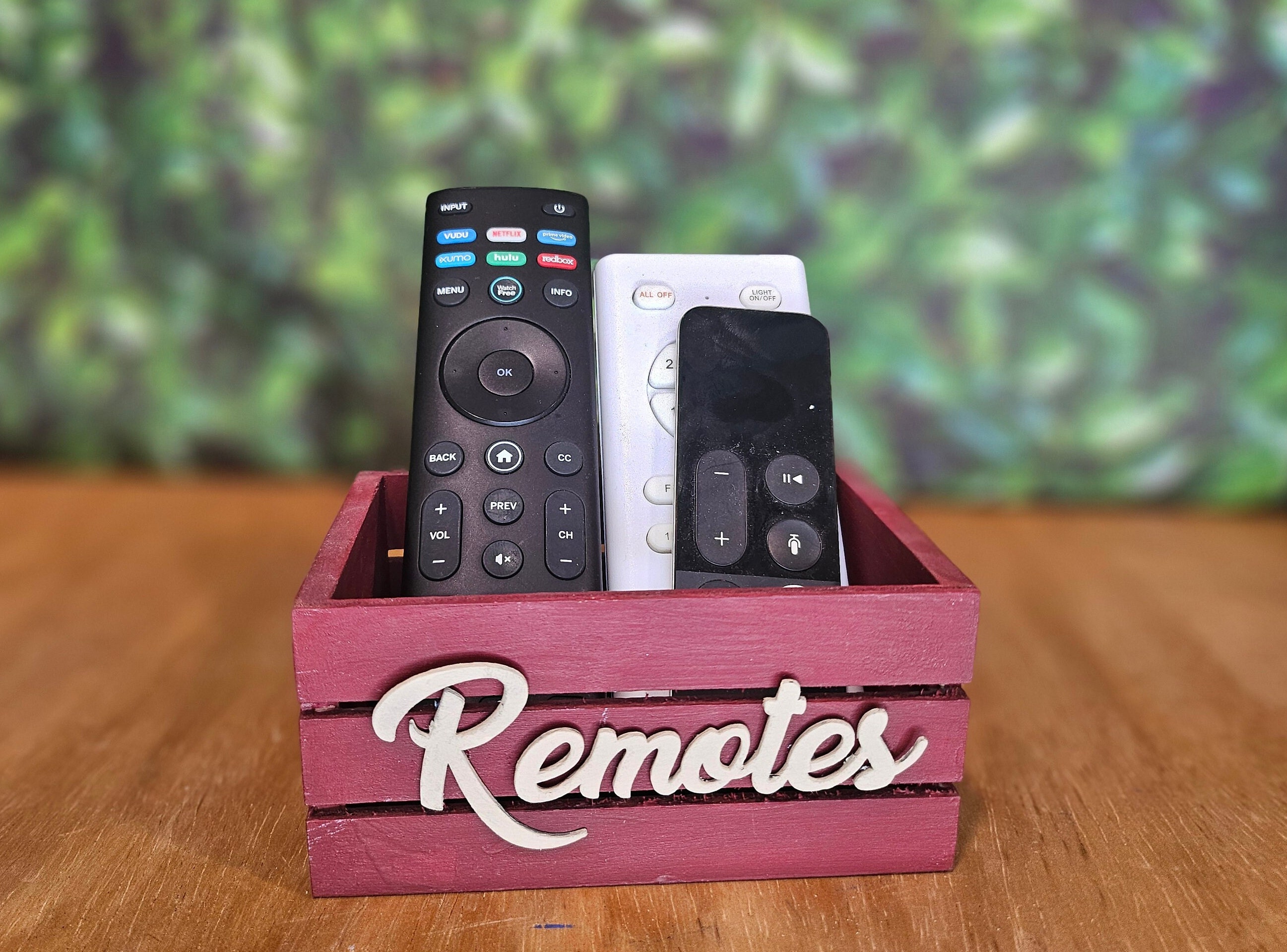 Red rust wooden mini crate with a beige Remotes word. The crate is perfect for farmhouse or modern decor. Ideal for home organization or decorative accents.