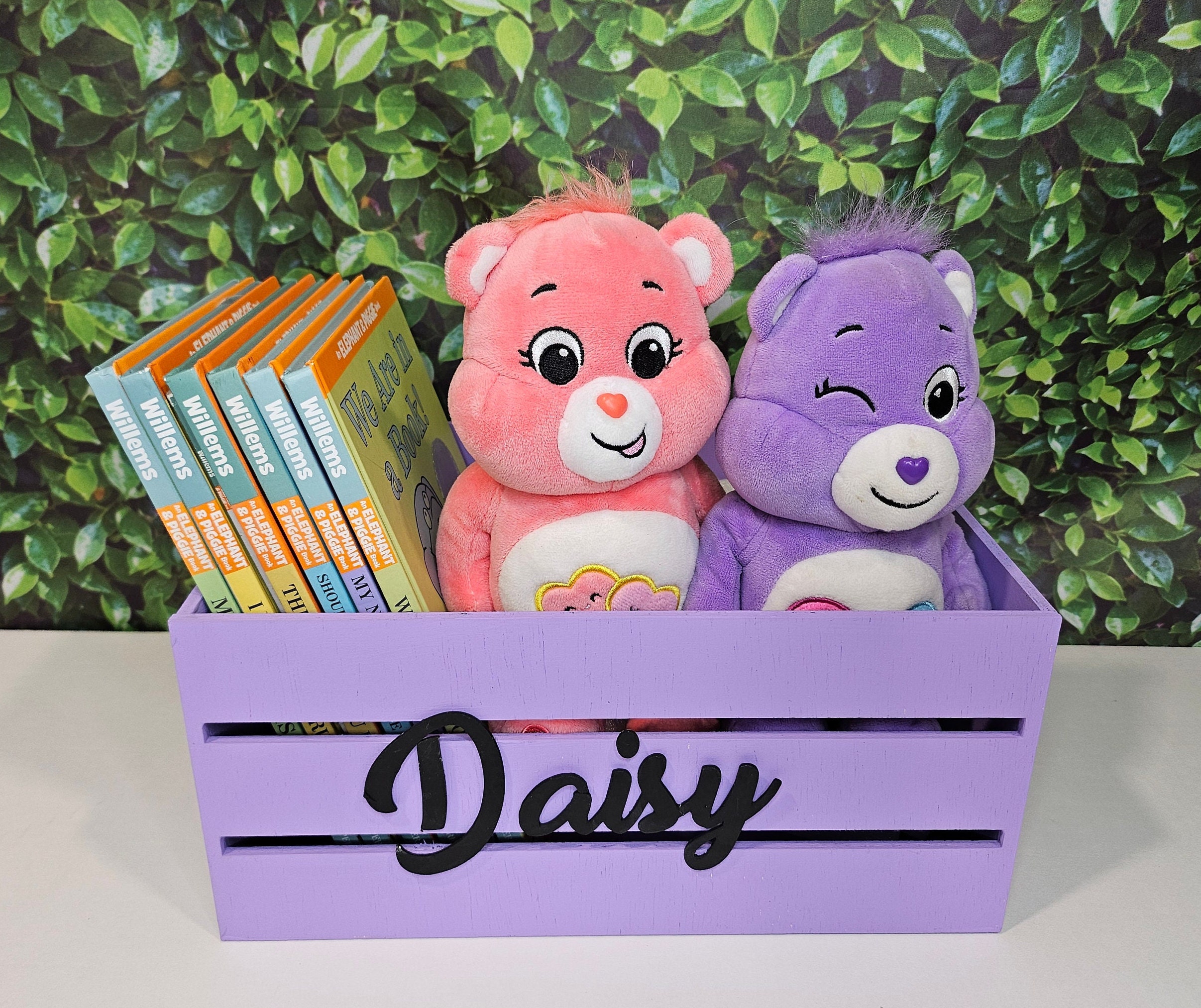 A purple wooden crate with black name. Perfect for a nursery or kids room decor.