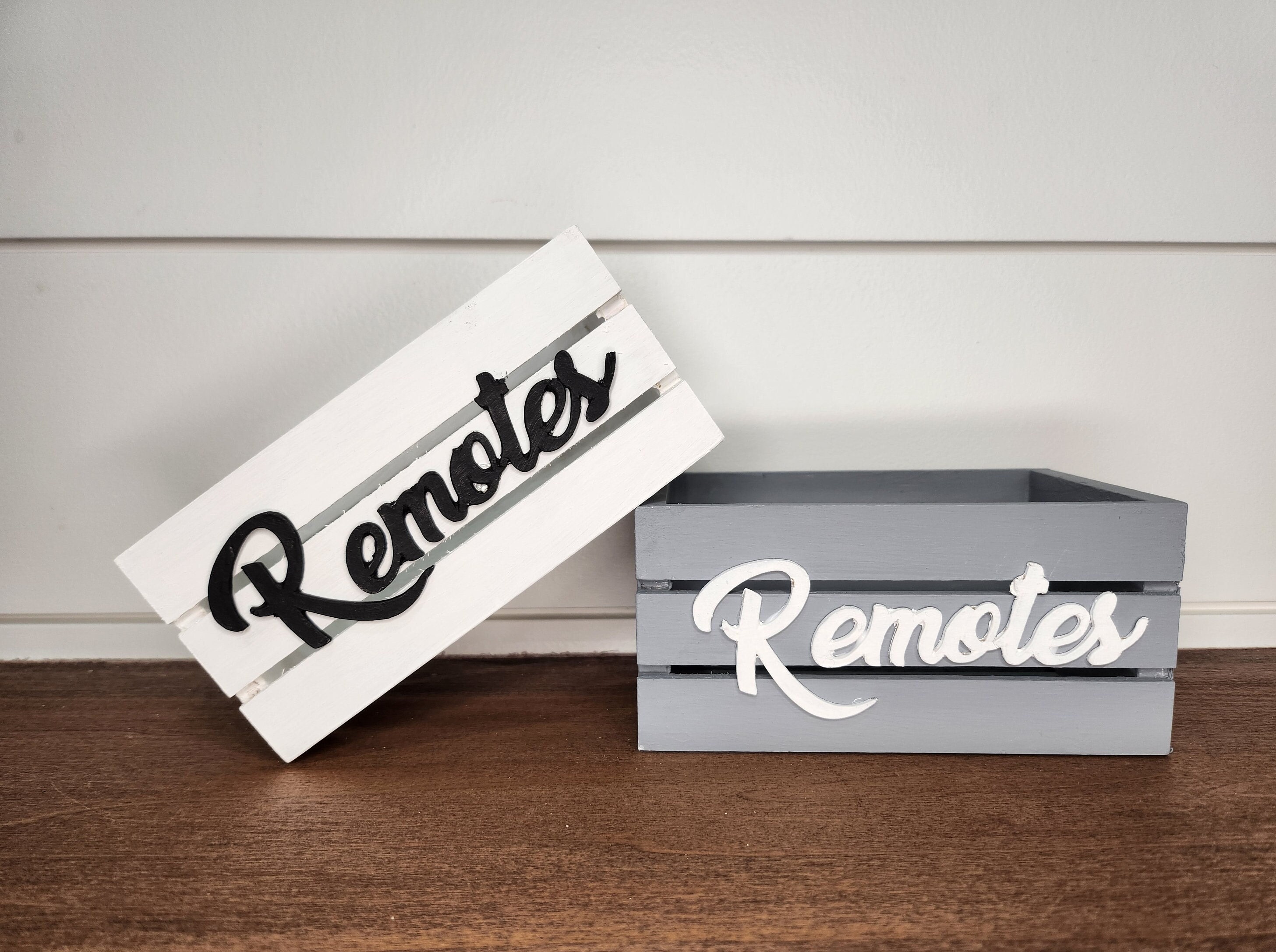 Two wooden mini crates with a Remotes word. The crate is perfect for farmhouse or modern decor. Ideal for remote controls organization and decorative accents.