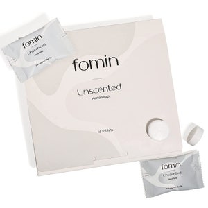 May include: A box of 16 unscented hand soap tablets from the brand Fomin. The box is white with a light brown background and the text "Fomin Unscented Hand Soap" is printed on the front. The box also includes the text "16 Tablets".