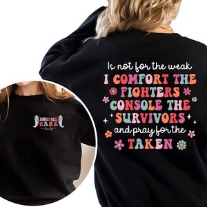 May include: Black sweatshirt with a colorful graphic print that reads "Is not for the weak I COMFORT THE FIGHTERS * CONSOLE THE * SURVIVORS + and pray for the * TAKEN *"