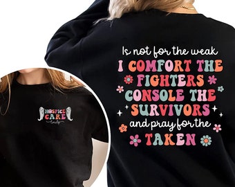 May include: Black sweatshirt with a colorful graphic print that reads "Is not for the weak I COMFORT THE FIGHTERS * CONSOLE THE * SURVIVORS + and pray for the * TAKEN *"