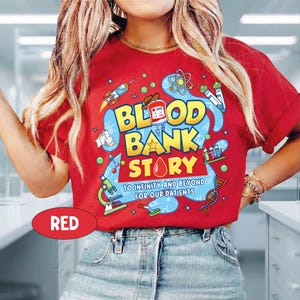 May include: Red t-shirt with a colorful graphic design. The design features the words "BLOOD BANK STORY" in yellow and blue, along with science-themed illustrations. The text "TO INFINITY AND BEYOND FOR OUR PATIENTS" is also included.