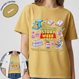 May include: Butter-colored t-shirt with a colorful graphic for Histology Story Week 2026. The design includes lab equipment, cells, and the text "SLICE, SLIDE, AND DECIDE". The shirt is a Comfort Colors brand.