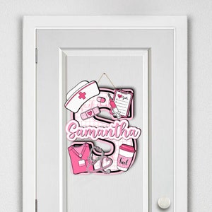 Wooden door sign with two-layer design, highlighting a large letter S with pink nurse-themed decorations. Personalized with the name Samantha, includes a nurse hat, stethoscope, and syringe. Perfect for nurse appreciation and decor.