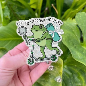 May include: A white ceramic mug with a black handle and the text "But First, Coffee" in a black, bold font. The mug is likely 11 ounces in size and sits on a white surface.