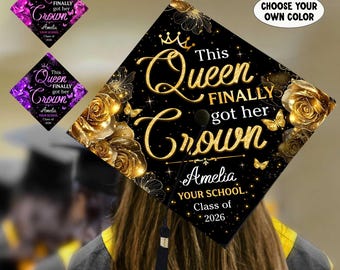 May include: A black graduation cap with gold floral and butterfly accents. The cap features the text "This Queen Finally Got Her Crown" in gold script, along with the graduate's name, school, and class year. Additional options are available to "Choose Your Own Color."