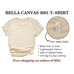 May include: A beige Bella Canvas 3001 T-shirt with a tear-away label. The label says "Canvas Bella Canvas". The shirt is lightweight, soft, and comfortable. It runs true to size.