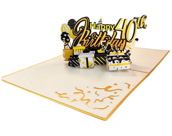 May include: A pop-up birthday card with a 3D design. The card features the words "Happy 40th Birthday" in black and yellow, along with illustrations of gifts, balloons, and a cake. The card is cream-colored with gold accents.