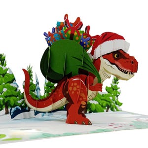 Könnte beinhalten: Eine 3D-Pop-up-Weihnachtskarte mit einem roten Tyrannosaurus Rex, der einen Weihnachtsmannhut trägt und einen grünen Sack voller Geschenke trägt. Die Szene spielt in einer verschneiten Landschaft mit Tannenbäumen im Hintergrund.