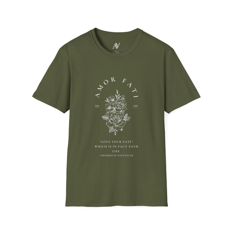 May include: A green t-shirt with a white graphic print of a floral design and the text "AMOR FATI" above the flowers. The text below the flowers reads "LOVE YOUR FATE" WHICH IS IN FACT YOUR LIFE -FRIEDRICH NIETZSCHE