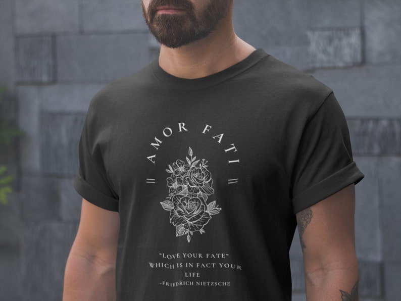 May include: Black t-shirt with a white floral design and the text "|| AMOR FATI ||" and "LOVE YOUR FATE" WHICH IS IN FACT YOUR LIFE -FRIEDRICH NIETZSCHE"