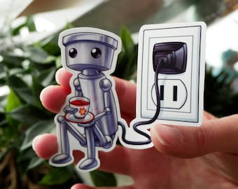 Op de afbeelding: Een zilveren robot met grote ogen houdt een klein theekopje vast met een rode vloeistof en een bloemetjespatroon. De robot is verbonden met een wit stopcontact met een zwart snoer.