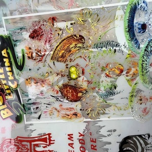 May include: Abstract artwork with the text "BIG TROUBLE IN LITTLE CHINA". The image features a mix of colors, including red, green, gold, and blue, with various shapes and patterns. The artwork has a layered, transparent effect.