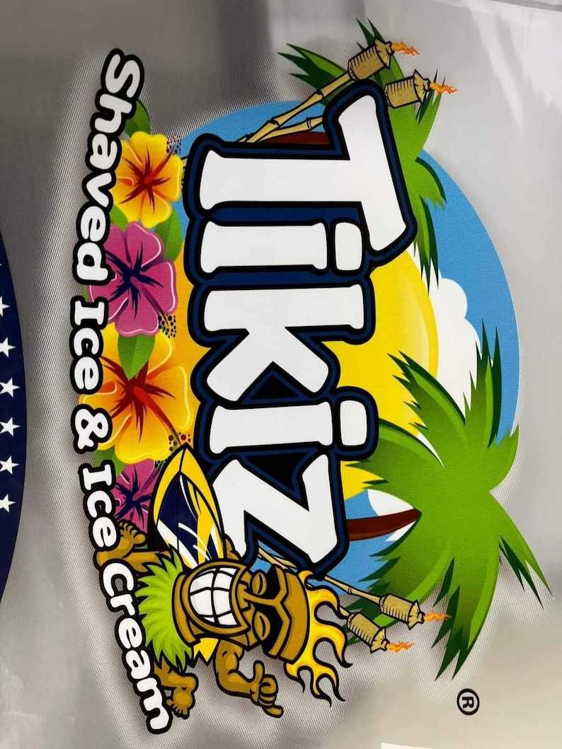 May include: A colorful Tiki-themed logo with the text "TikiZ Shaved Ice & Ice Cream". The design features a smiling tiki character, tropical flowers, palm trees, and torches against a blue and yellow background.
