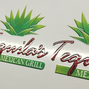 May include: A close-up of a silver and white sticker with a green agave plant and the text "Tequila's Tequila" in red lettering. The text "Mexican Grill" is also included in green lettering.