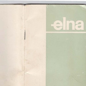 May include: A white and green pamphlet with the word "elna" printed in black on the front cover.