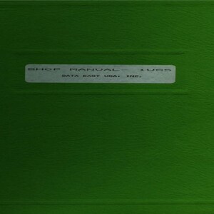 May include: A green book cover with the text "SHOP MANUAL - 1955" on a white label. The text "DATA EAST USA, INC." is also visible on the label. The cover has a textured appearance.