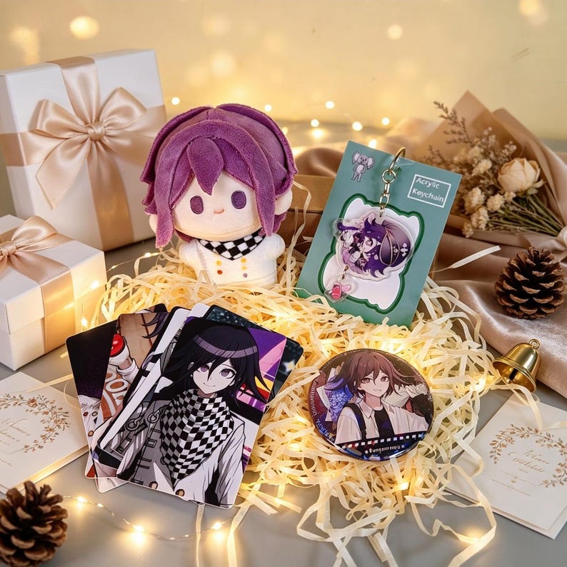 May include: A gift set featuring a purple-haired plush doll, an acrylic keychain with a character illustration, a circular pin-back button, and several rectangular character cards, all nestled in shredded paper with string lights.