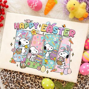 May include: A cream-colored Easter-themed graphic featuring Snoopy characters with bunny ears, holding Easter eggs and baskets. The words "Happy Easter" are in colorful letters above the characters. Decorative eggs, a carrot, and a chick are scattered around the image.
