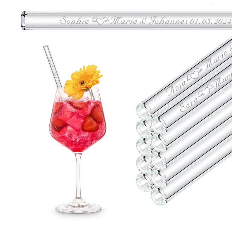 May include: A set of 10 clear glass drinking straws with personalized engravings. The straws are stacked and feature names like "Anja" and "Sara" with heart symbols. One straw is shown in a glass of pink cocktail with a yellow flower garnish.