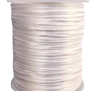 May include: A spool of white waxed cord, ideal for jewellery making, macrame, or crafts.
