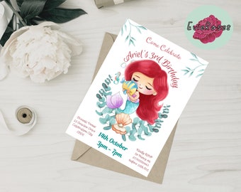 May include: A white invitation card with a watercolor illustration of a mermaid with red hair holding a yellow fish. The text on the card reads "Come Celebrate Ariel's 3rd Birthday". The invitation includes the date and time of the event, as well as the venue address.