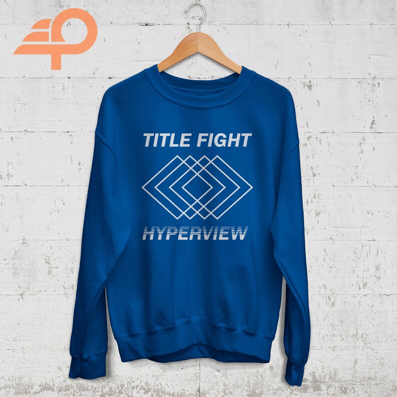 May include: A royal blue sweatshirt with the text "TITLE FIGHT" and a white geometric design. The text "HYPERVIEW" is below the design.