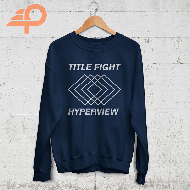 May include: Navy blue sweatshirt with a white graphic design featuring the text "TITLE FIGHT" and a geometric pattern. The text "HYPERVIEW" is below the pattern.