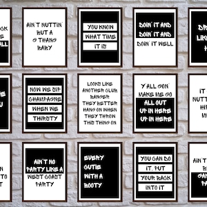 May include: A series of framed art prints with black and white text. Each print displays a different phrase in a bold, stylized font. The prints are hung against a white brick wall, creating a modern aesthetic.