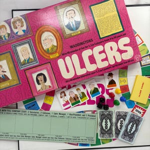 May include: A vintage board game called "ULCERS" with a pink box featuring portraits. The game includes cards, dice, and play money. The box text indicates the game is for 2-4 players aged 9-90. The game board and cards are visible.