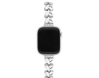 May include: Silver-toned smartwatch with a black screen and a heart-shaped link band. The band is made of multiple heart-shaped links, creating a delicate and stylish design. The watch has a square face with rounded corners.