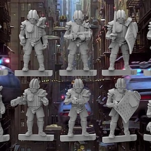 Puede incluir: Una colección de diez figuras en miniatura grises de soldados futuristas. Cada figura posa con diferentes armas y escudos, incluyendo blásters, espadas y escudos protectores. Las figuras están sobre bases rectangulares, con un fondo borroso de ciudad.