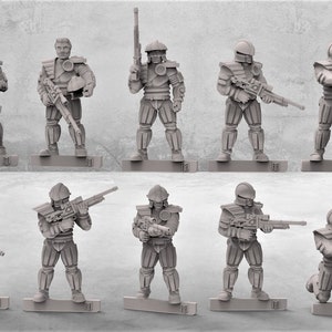 May include: A set of ten gray plastic miniature figures of soldiers, some holding rifles, some holding other weapons, and some kneeling. The figures are all in various poses and are standing on small gray bases.