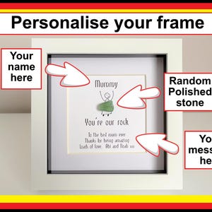 May include: A framed print with the text "Personalise your frame". The white frame contains a print with the word "Mummy" and the phrase "You're our rock". The frame has space for a name and a message.
